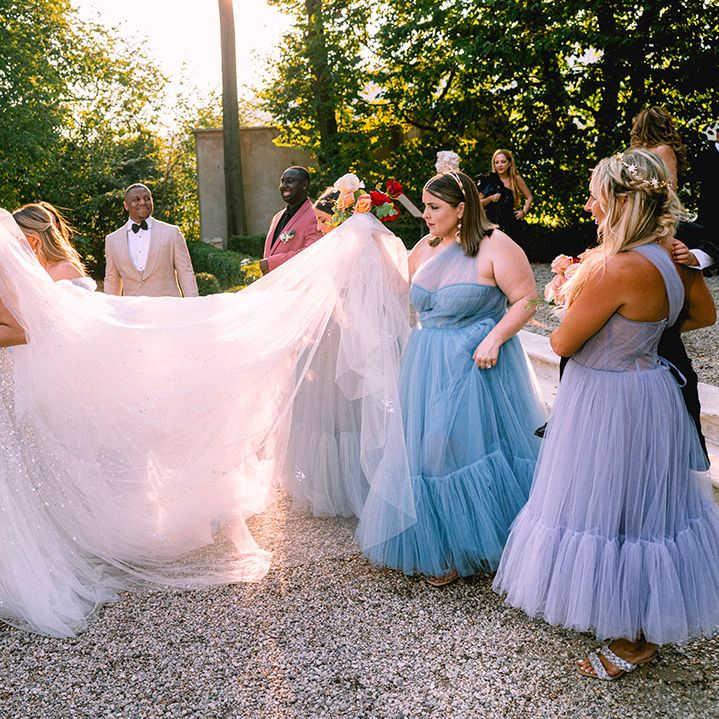 bridesmaids-help-bride-with-wedding-dress-and-veil