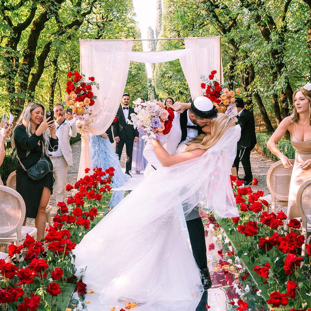 groom-kisses-bride-at-outdoor-wedding-ceremony