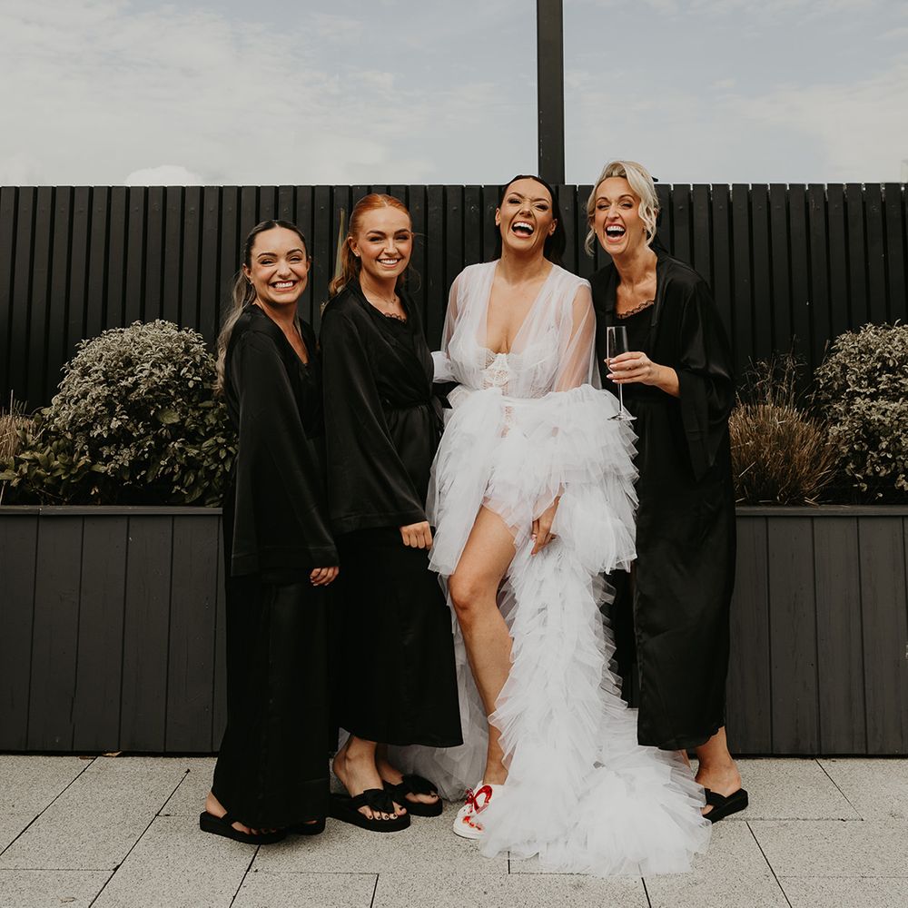 bridal-party-wearing-black-robes-and-bride-in-white-tulle-robe