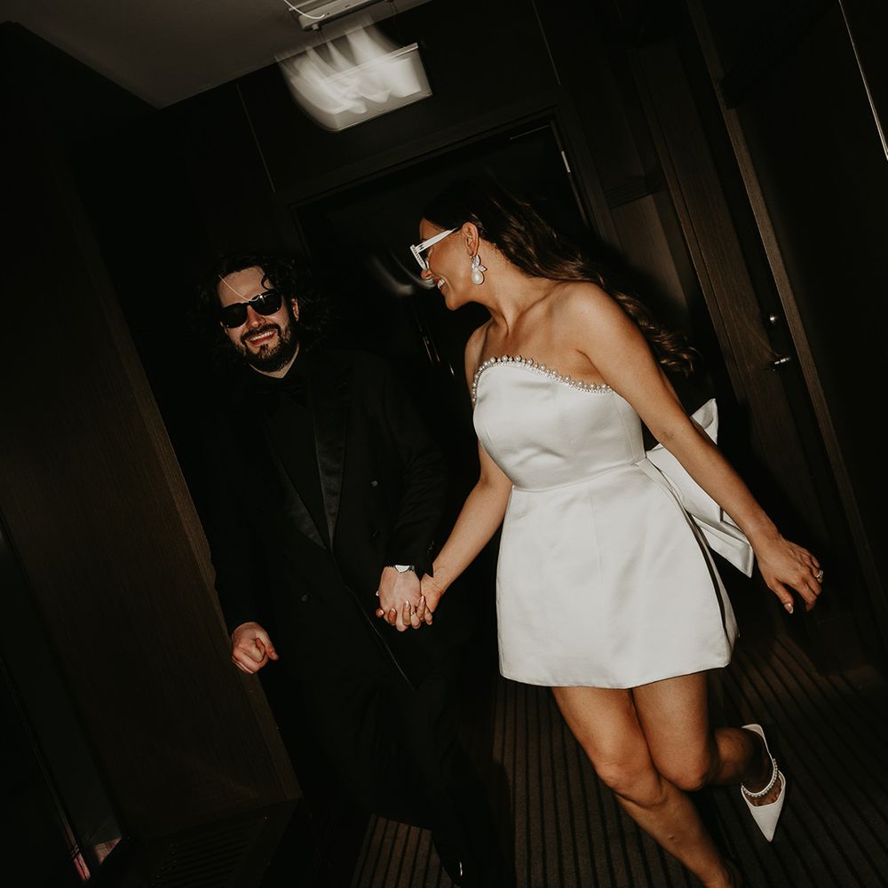 bride-in-short-strapless-wedding-reception-dress-with-bow