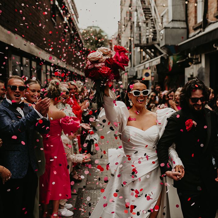confetti-moment-for-bride-and-groom-as-they-celebrate-with-brass-band