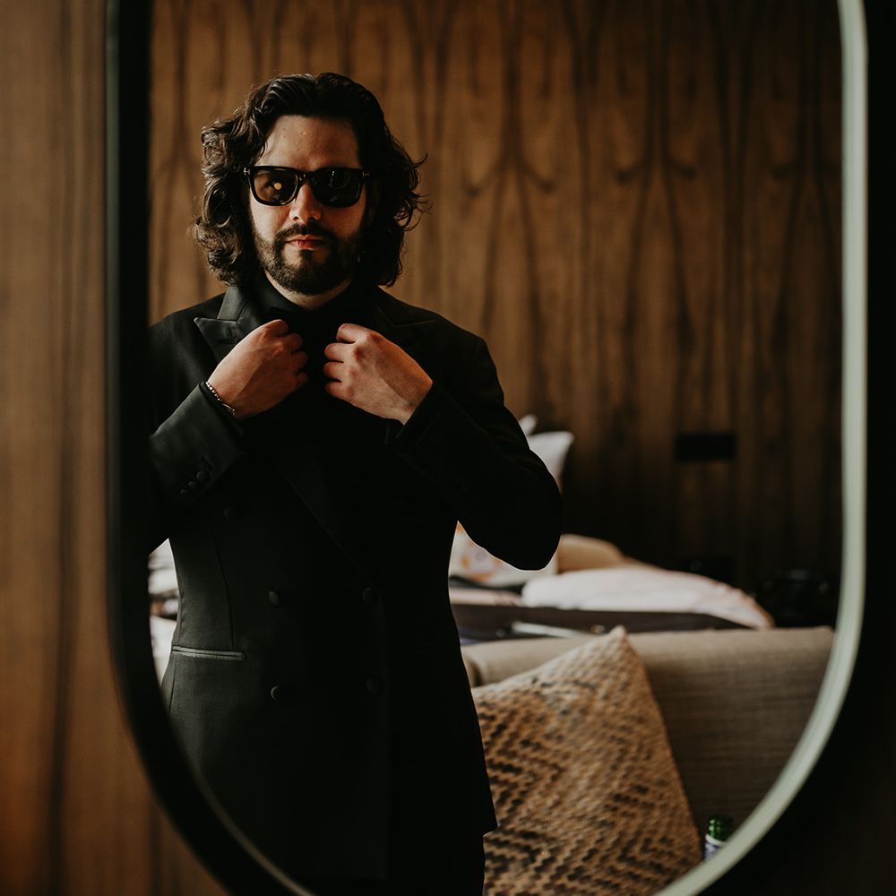 groom-wearing-all-black-wedding-suit-with-sunglasses