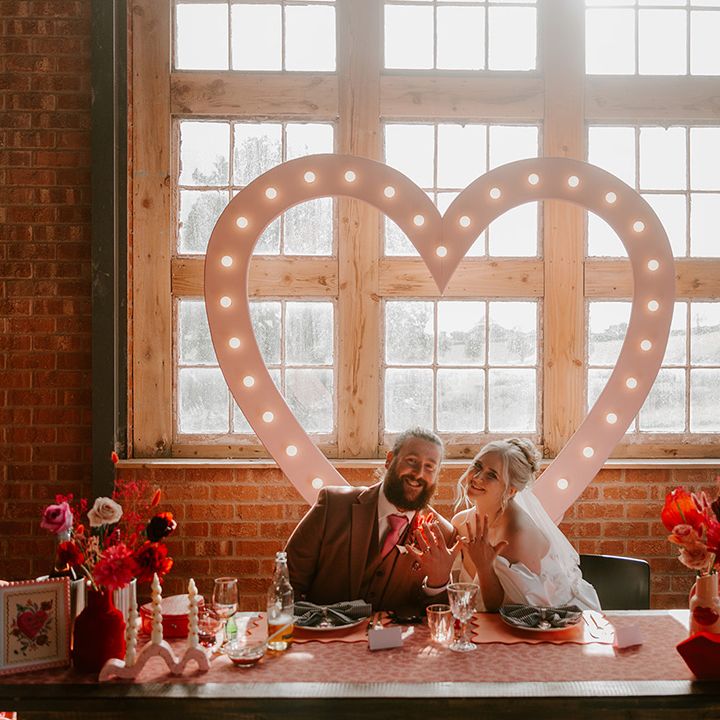 sweetheart-table-for-bride-and-groom-showing-off-rings