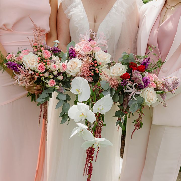 bride-and-bridesmaid-wedding-bouquets-with-white-orchids-and-roses