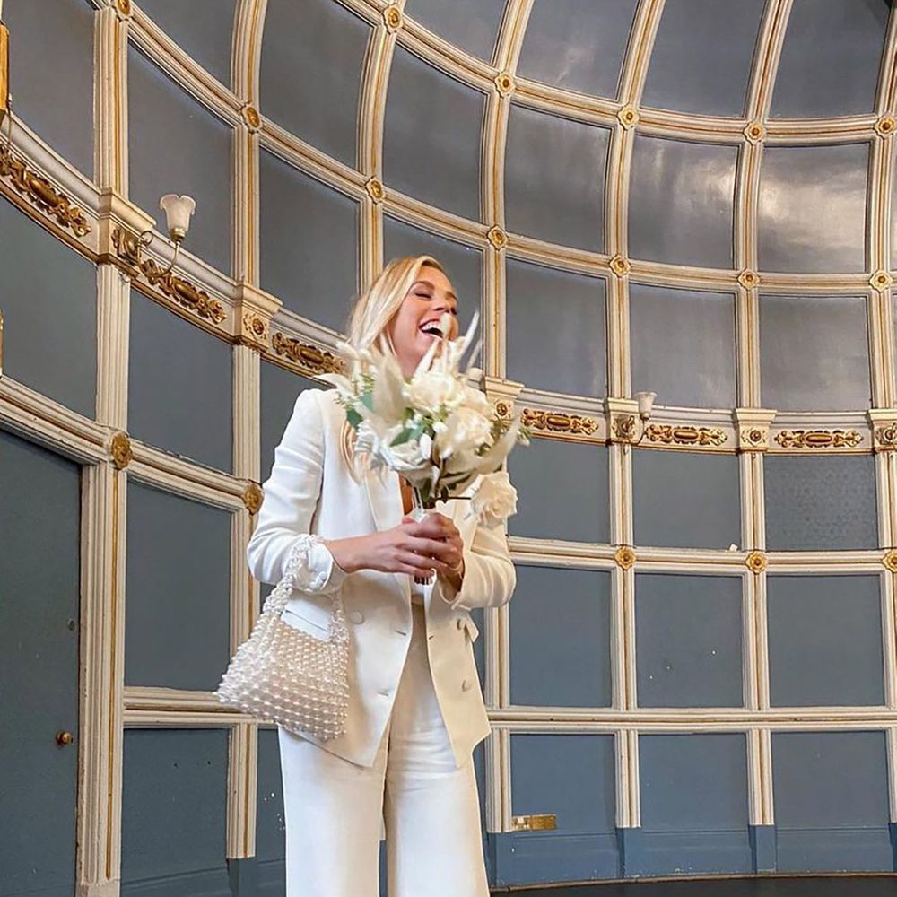 bride holding rented shrimps bag for wedding day from by rotation