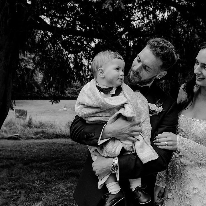 bride-and-groom-with-baby-boy-in-black-tuxedo
