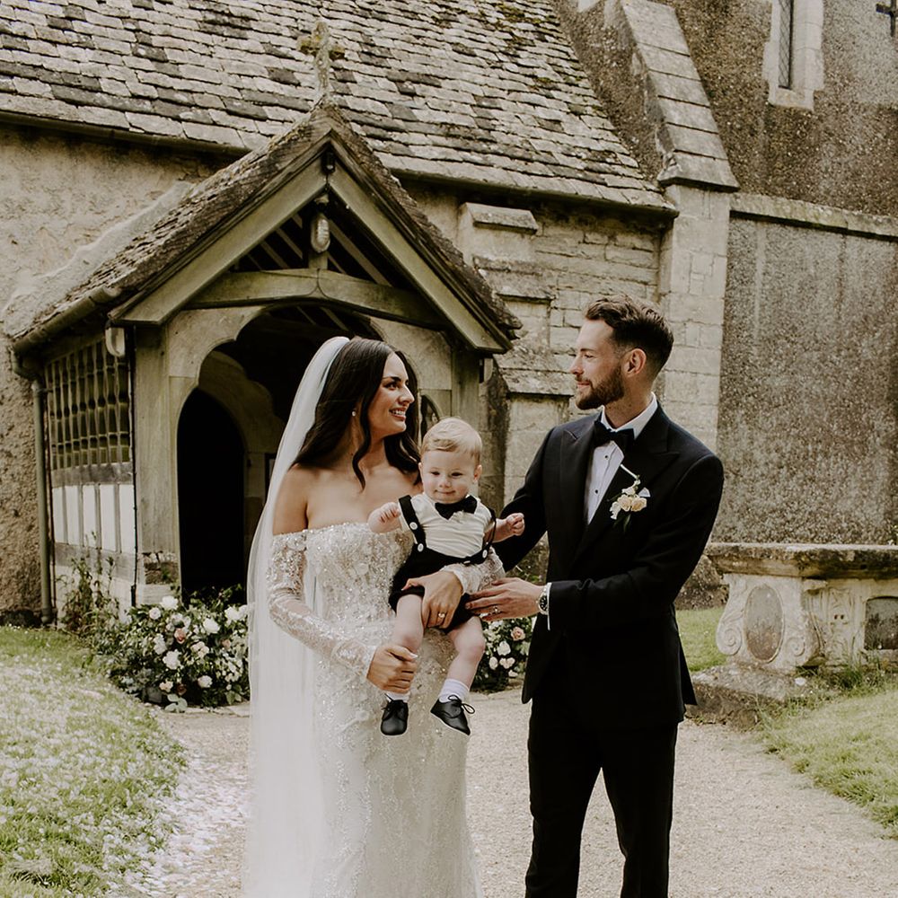 bride-and-groom-with-their-son-wearing-black-tuxedo