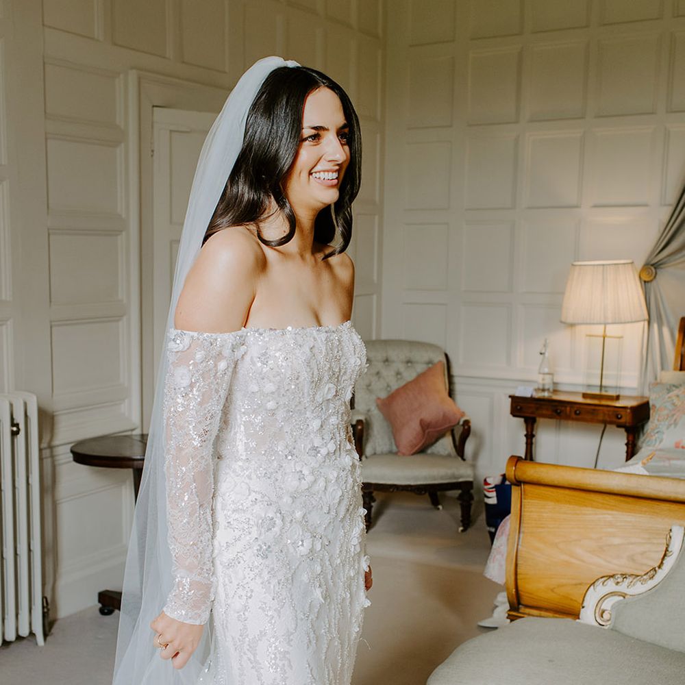bride-in-off-the-shoulder-wedding-dress-getting-ready-for-wedding