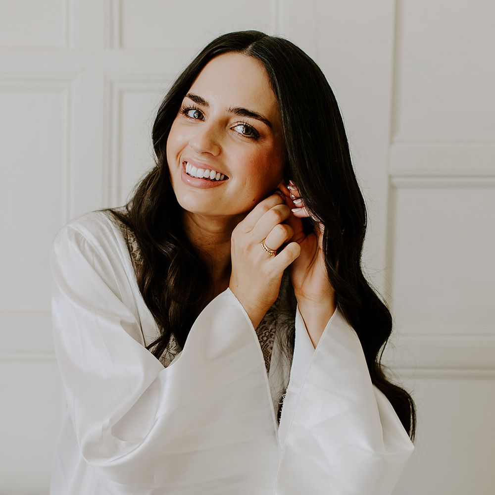 bride-putting-in-earrings-for-wedding