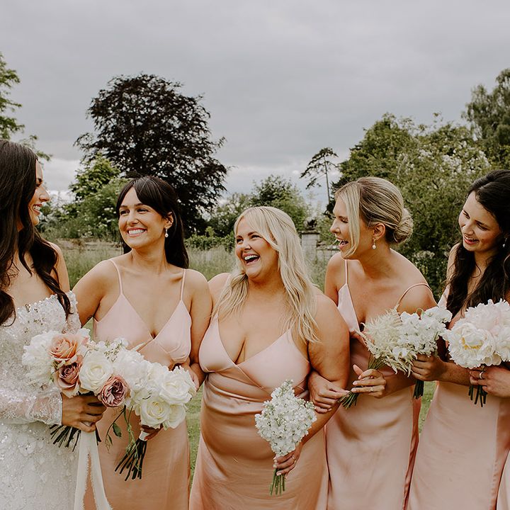 bridesmaids-wearing-pink-satin-bridesmaid-dresses-with-bride