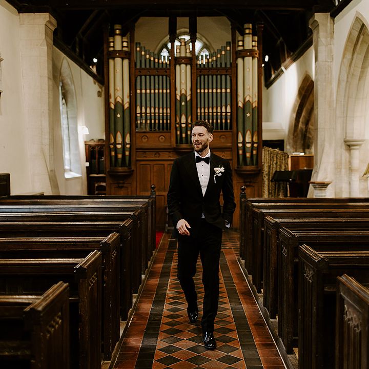 groom-in-black-tuxedo-at-church-ceremony