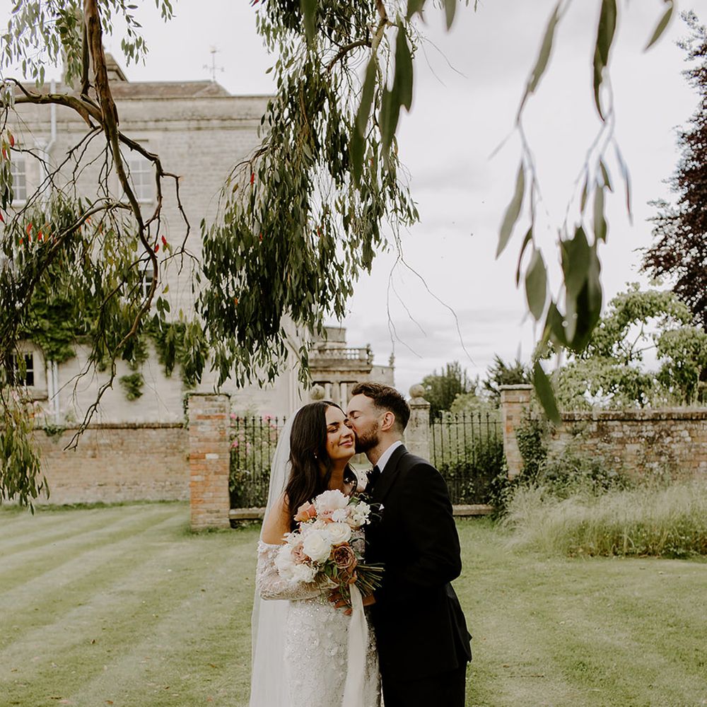 groom-kisses-bride-at-elmore-court-wedding