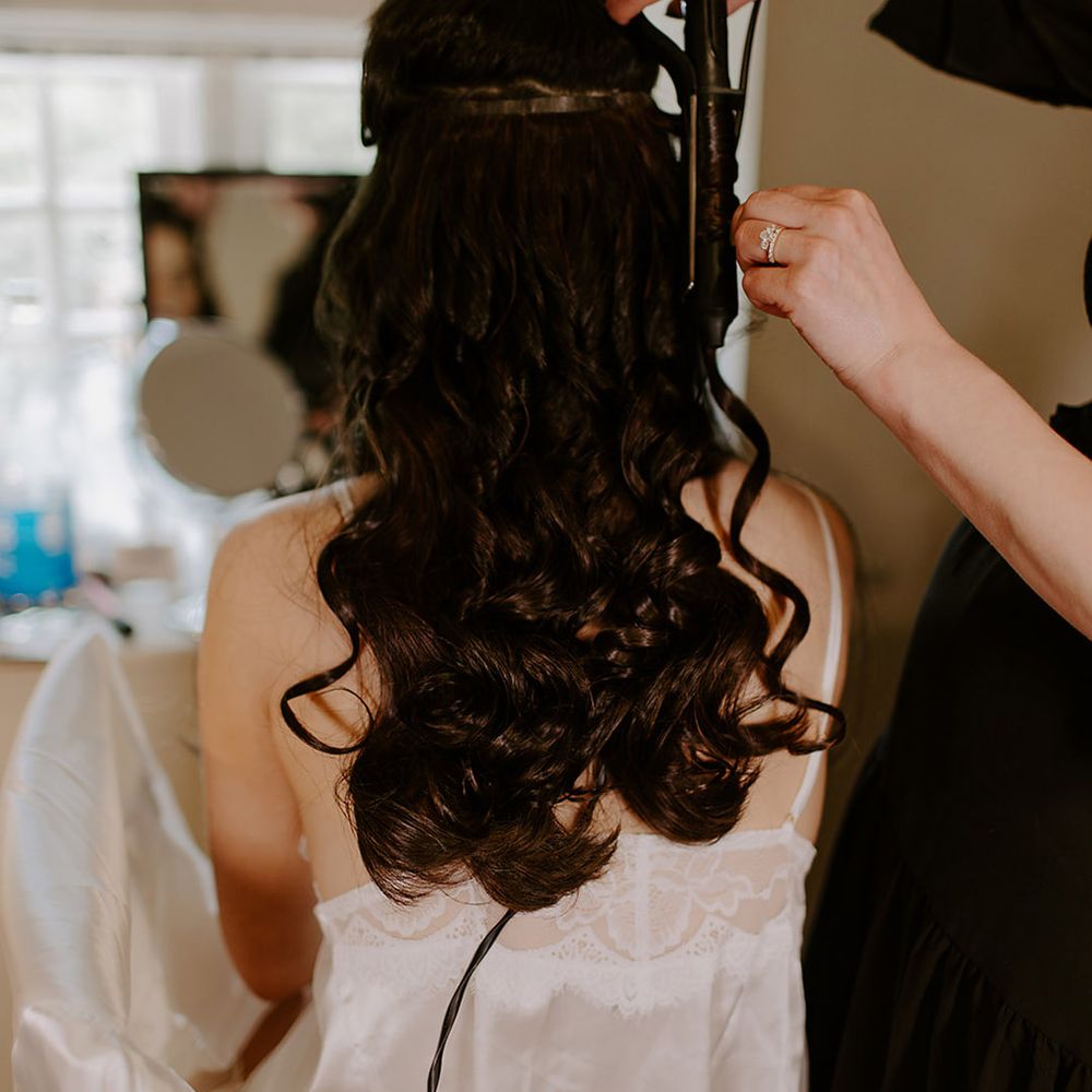 wedding-hair-getting-curled-with-hair-extensions