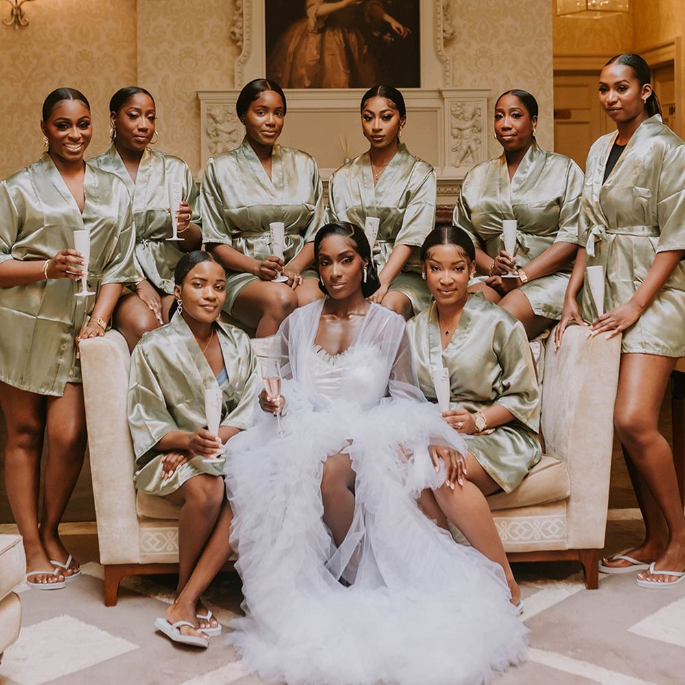 bridesmaids-wearing-green-satin-robes-with-bride-in-white-tulle-robe