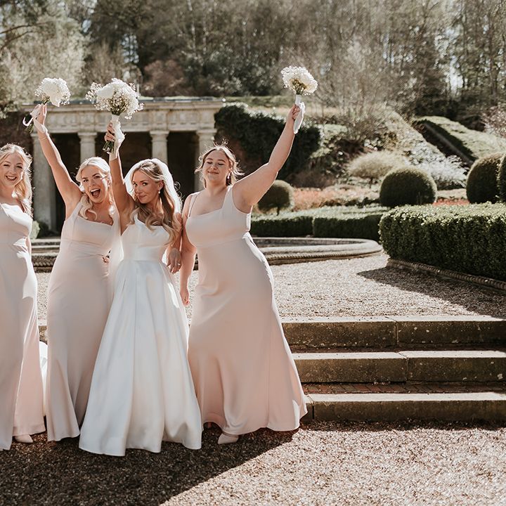 bridal-party-waving-their-bouquets-in-the-air