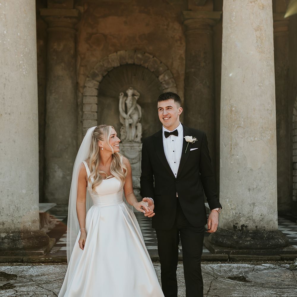 groom-in-black-tuxedo-with-bride-in-princess-wedding-dress