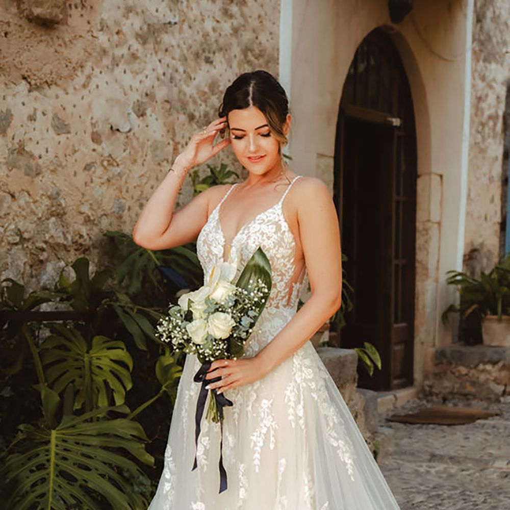 bride wearing lace tulle wedding dress with plunge neckline
