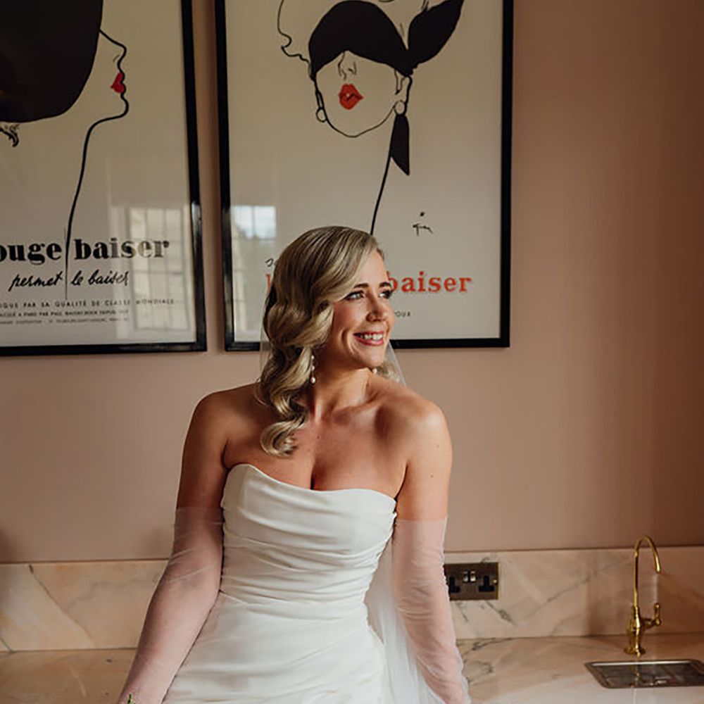 bride wearing ruched strapless wedding dress with leg split 