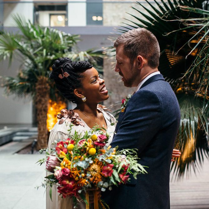 Bride in Bespoke Ailsa Monroe Jumpsuit & Cape | Groom in Next Navy Wool Suit | Relaxed Industrial Wedding at Ocean Studios, Plymouth | Freckle Photography