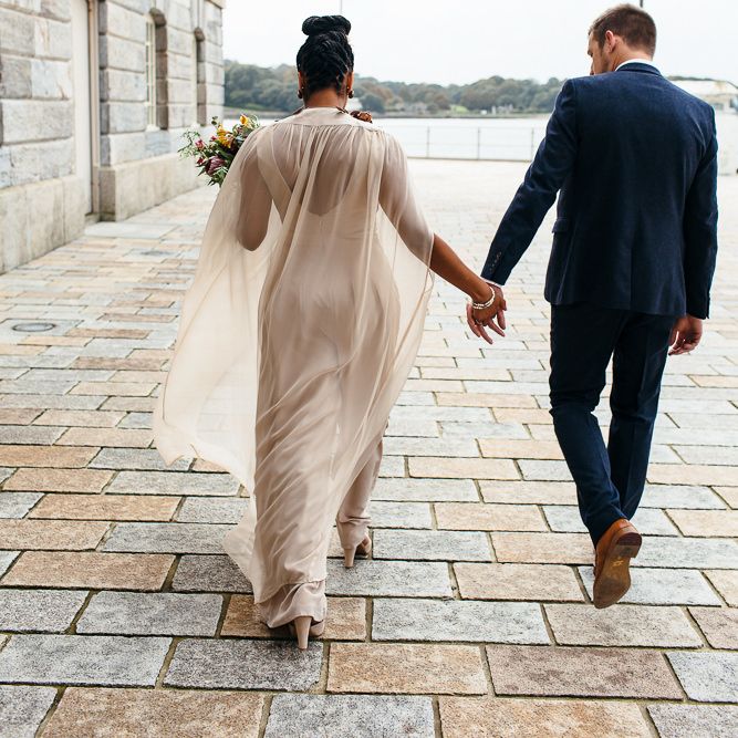 Bride in Bespoke Ailsa Monroe Jumpsuit & Cape | Groom in Next Navy Wool Suit | Relaxed Industrial Wedding at Ocean Studios, Plymouth | Freckle Photography