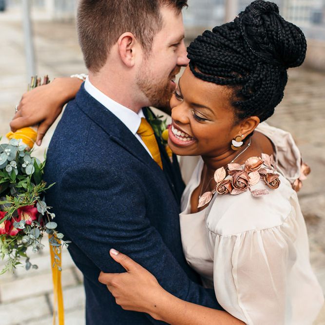 Bride in Bespoke Ailsa Monroe Jumpsuit & Cape | Groom in Next Navy Wool Suit | Relaxed Industrial Wedding at Ocean Studios, Plymouth | Freckle Photography