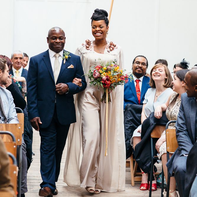Wedding Ceremony | Bride in Bespoke Ailsa Monroe Jumpsuit & Cape | Father of The Bride in Navy Suit | Relaxed Industrial Wedding at Ocean Studios, Plymouth | Freckle Photography