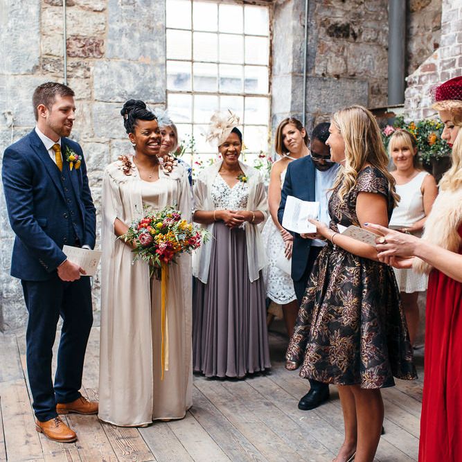 Wedding Ceremony | Bride in Bespoke Ailsa Monroe Jumpsuit & Cape | Groom in Next Navy Wool Suit | Relaxed Industrial Wedding at Ocean Studios, Plymouth | Freckle Photography