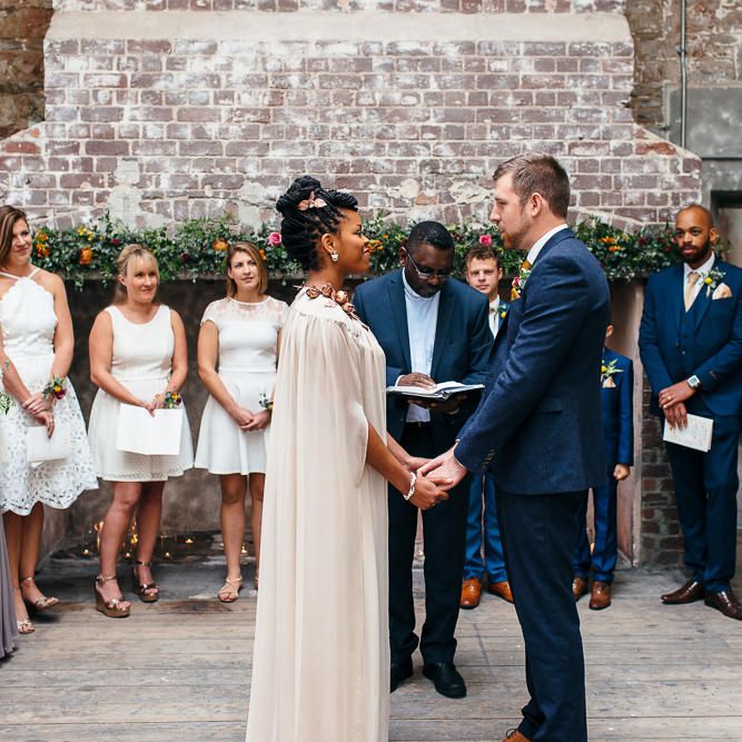 Wedding Ceremony | Bride in Bespoke Ailsa Monroe Jumpsuit & Cape | Groom in Next Navy Wool Suit | Relaxed Industrial Wedding at Ocean Studios, Plymouth | Freckle Photography