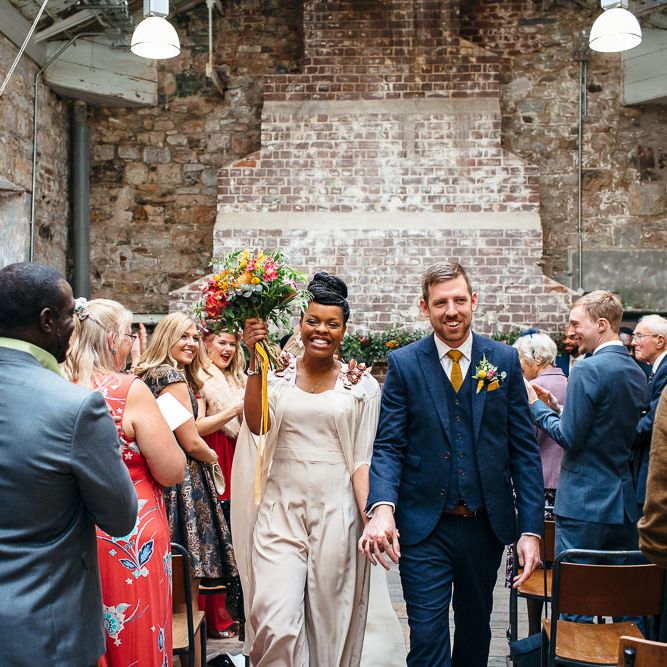 Wedding Ceremony | Bride in Bespoke Ailsa Monroe Jumpsuit & Cape | Groom in Next Navy Wool Suit | Relaxed Industrial Wedding at Ocean Studios, Plymouth | Freckle Photography