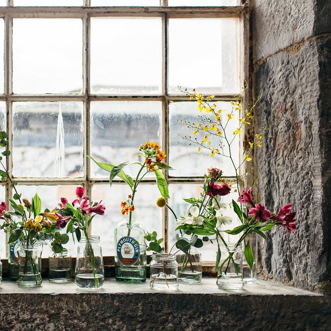Flower Stems in Bottles | | Relaxed Industrial Wedding at Ocean Studios, Plymouth | Freckle Photography