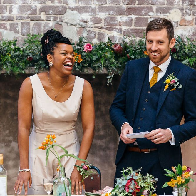 Wedding Speeches | Bride in Bespoke Ailsa Monroe Jumpsuit & Cape | Groom in Next Navy Wool Suit | Relaxed Industrial Wedding at Ocean Studios, Plymouth | Freckle Photography