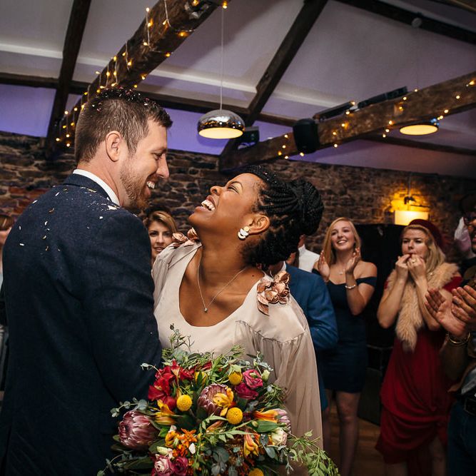 First Dance | Bride in Bespoke Ailsa Monroe Jumpsuit & Cape | Groom in Next Navy Wool Suit | Relaxed Industrial Wedding at Ocean Studios, Plymouth | Freckle Photography