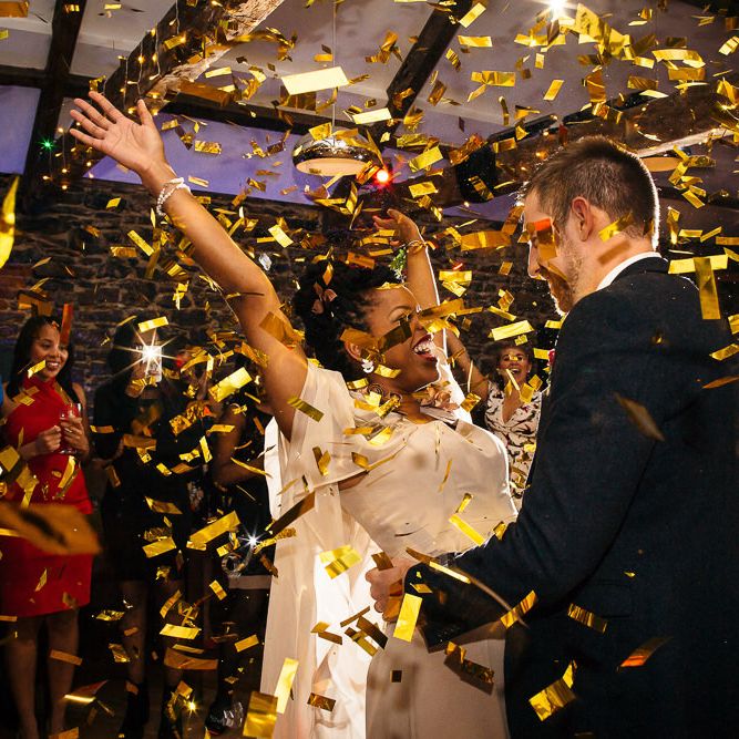 Confetti Bomb | Bride in Bespoke Ailsa Monroe Jumpsuit & Cape | Groom in Next Navy Wool Suit | Relaxed Industrial Wedding at Ocean Studios, Plymouth | Freckle Photography