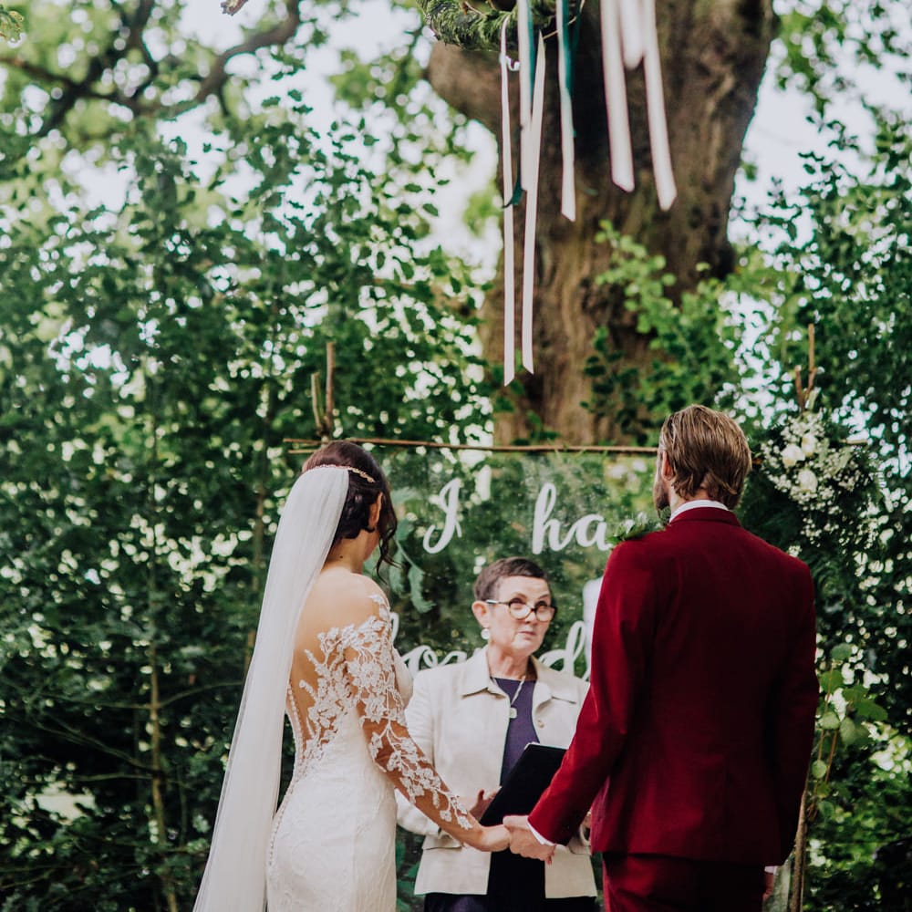 Outdoor Wedding Ceremony | Bride in Rosa Clara Naim Bridal Gown | Groom in Bespoke Burgundy Suit | Stylish Woodland Wedding in Cheshire | Clara Cooper Photography | Story Board Weddings Films
