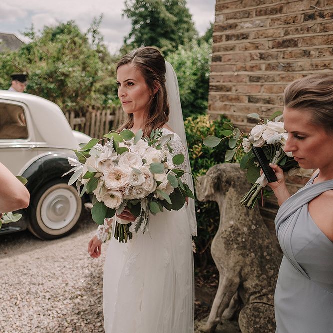 Bride in Lace Pronovias Wedding Dress | Bridesmaids in Grey Dessy Dresses | White and Silver English Country Garden At Home Marquee Wedding | Jason Mark Harris Photography