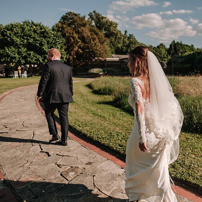 Bride in Lace Pronovias Bridal Gown | Groom in Thom Sweeney Suit | White and Silver English Country Garden At Home Marquee Wedding | Jason Mark Harris Photography