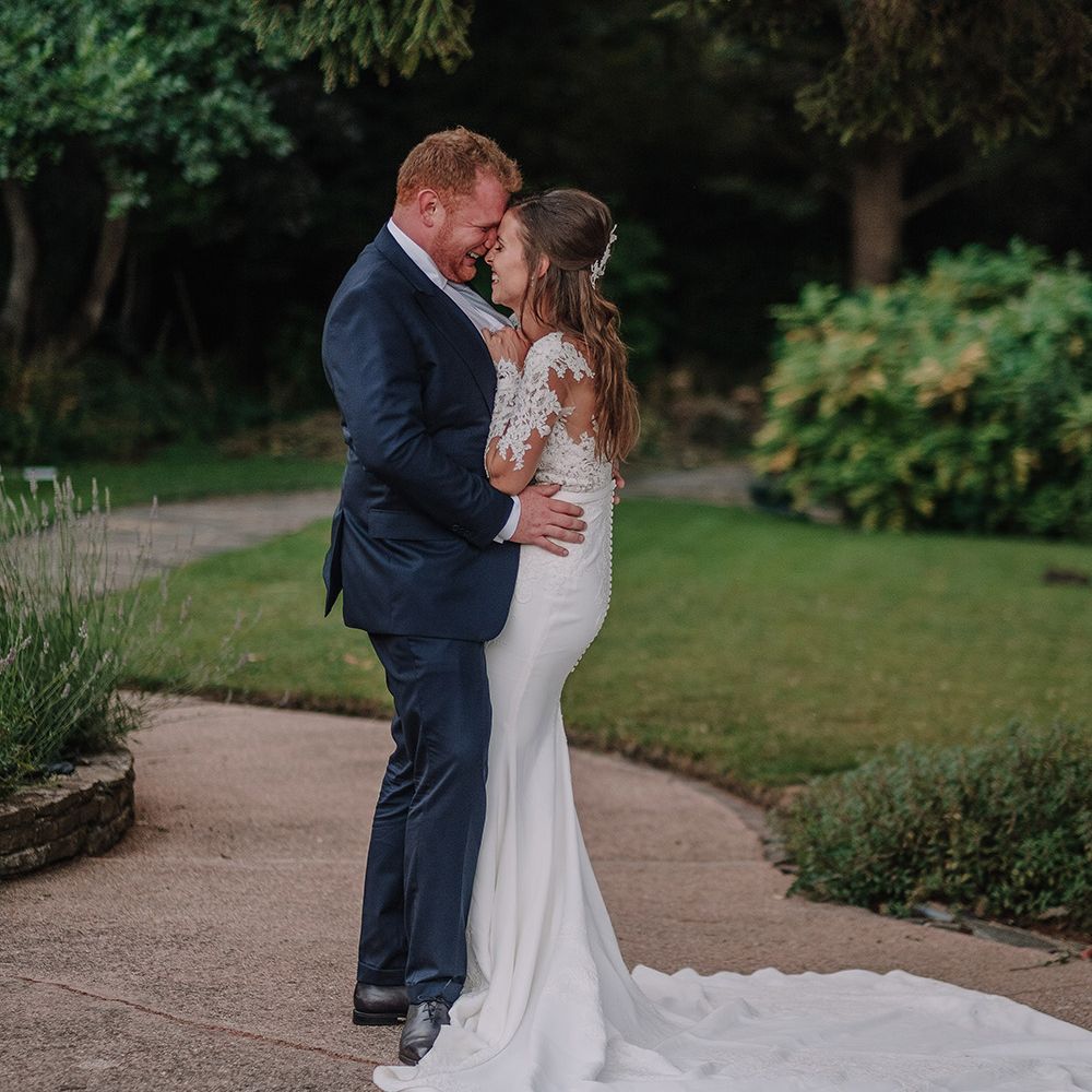 Bride in Lace Pronovias Bridal Gown | Groom in Thom Sweeney Suit | White and Silver English Country Garden At Home Marquee Wedding | Jason Mark Harris Photography