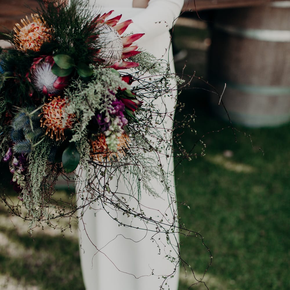 Protea Wedding Bouquet | Bride in Houghton NYC Bridal Gown | Stylish Outdoor Wedding at The Oaks Estate, Greyton, South Africa | Fiona Clair Photography | Ebert Steyn Films