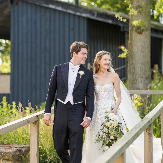 Bride in Mira Zwillinger Bridal Gown | Groom in Black Tie | Rustic Soho Farmhouse Ceremony with PapaKata Sperry Tent Greenery filled Reception | Marianne Taylor Photography | Will Warr Films