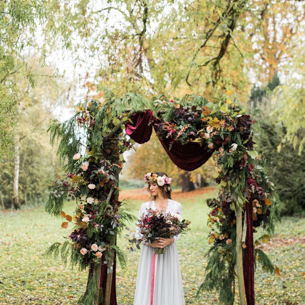 Woodland Floral Arch | Bride in Tulle | Autumnal Decadence Wedding Inspiration at Twyning Park Styled by For The Love of Weddings | Red, Gold & Blush Colour Scheme | Captured by Katrina Photography