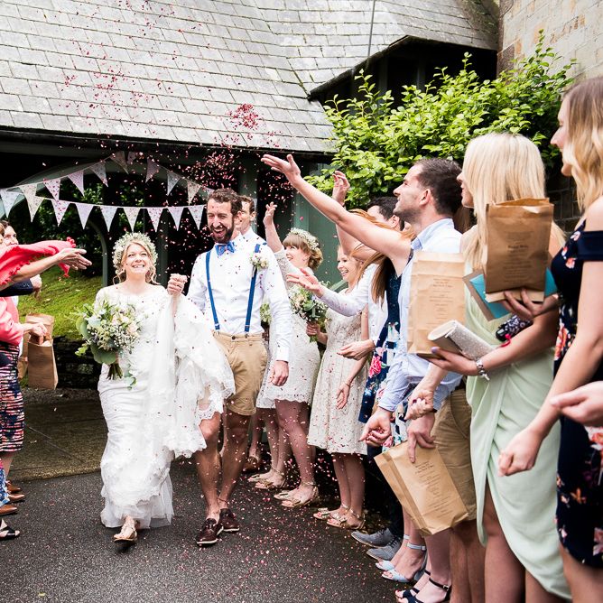 Confetti Moment | Bride in Lace Wedding Dress | Groom in Shorts, Braces & Bow Tie | Coastal Wedding at Driftwood Spas St Agnes, Cornwall | Jessica Grace Photography