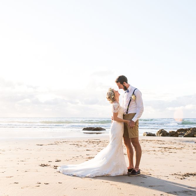 Beach Portrait | Bride in Lace Wedding Dress | Groom in Shorts, Braces & Bow Tie | Coastal Wedding at Driftwood Spas St Agnes, Cornwall | Jessica Grace Photography
