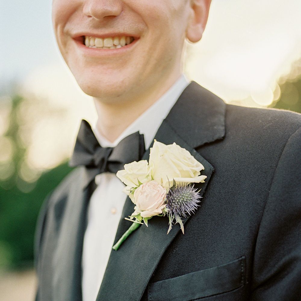 Buttonhole | Groom in Black Tuxedo | Classic Blue & White Wedding at Prestwold Hall in Loughborough | Georgina Harrison Photography