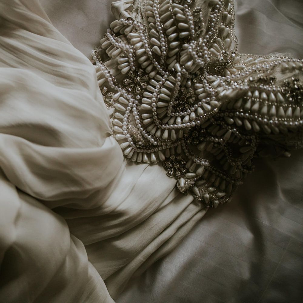 Close up of white beaded wedding dress 