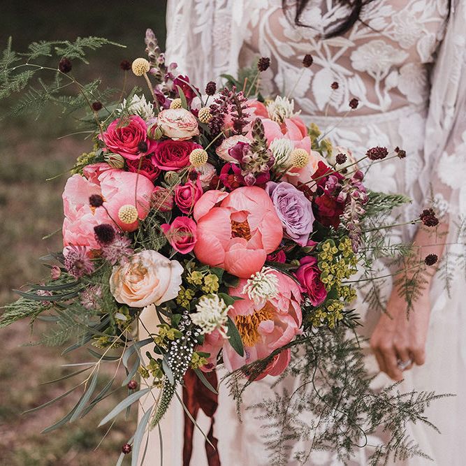 Close up of bride holding rustic pink wedding bouquet