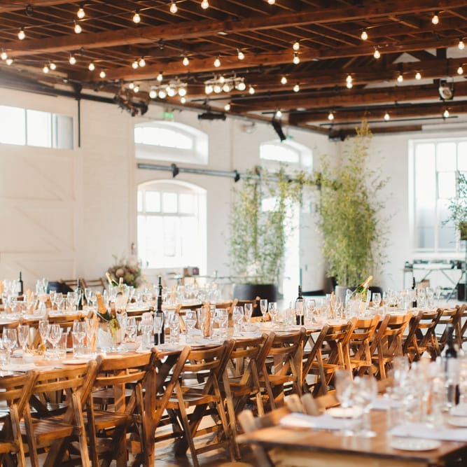 Warehouse Wedding With Wooden Chairs & Foliage Installation | Images by Frances Sales