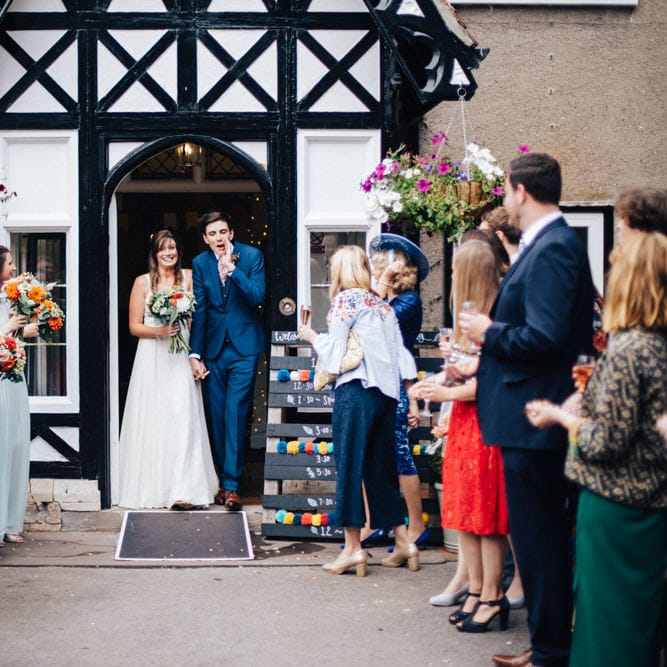 Confetti Exit | Bride in Bespoke Gown | Groom in Navy Blue Suit | Colourful DIY Wedding at Barley Wood Country House in Somerset | A Thing Like That Photography