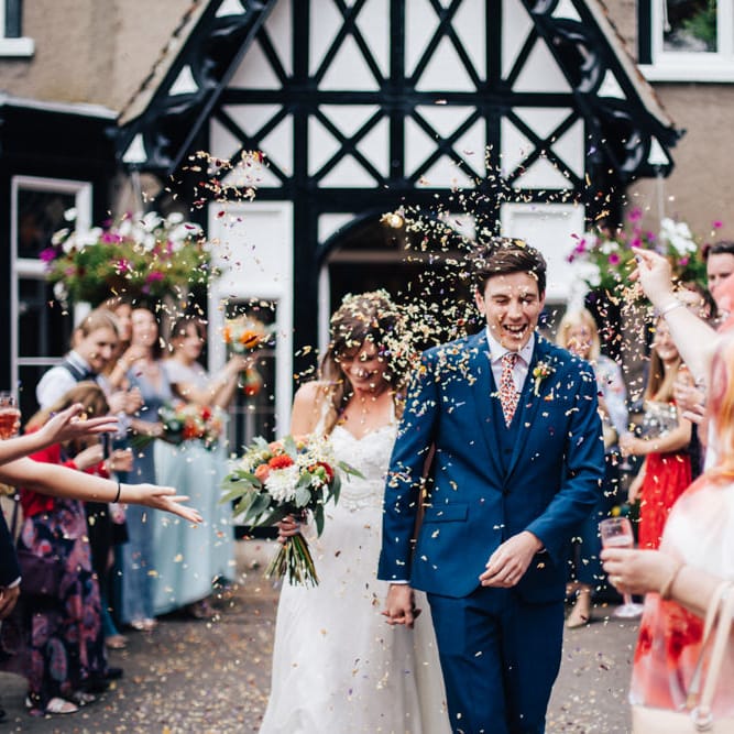Confetti Exit | Bride in Bespoke Gown | Groom in Navy Blue Suit | Colourful DIY Wedding at Barley Wood Country House in Somerset | A Thing Like That Photography