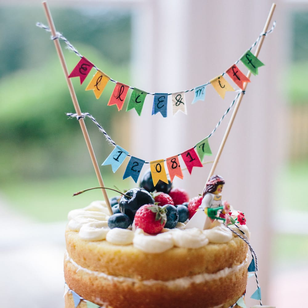 Mini Bunting Wedding Cake Topper | Colourful DIY Wedding at Barley Wood Country House in Somerset | A Thing Like That Photography