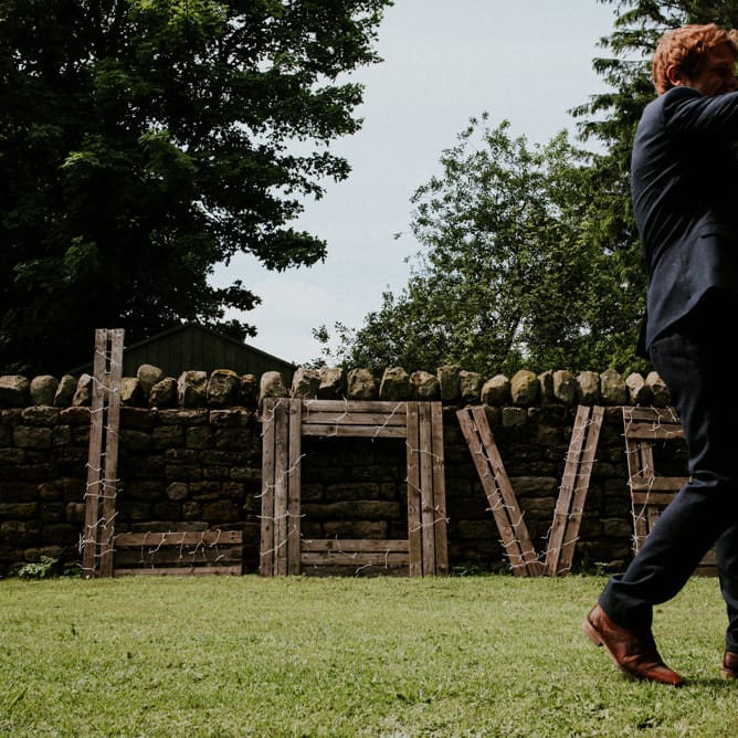 Wood LOVE Sign wrapped in Fairy Lights | Wedding Decor | Colourful Outdoor Wedding at Lineham Farm in Leeds | Shutter Go Click Photography